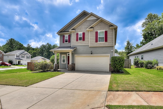 craftsman house with a garage and a front lawn