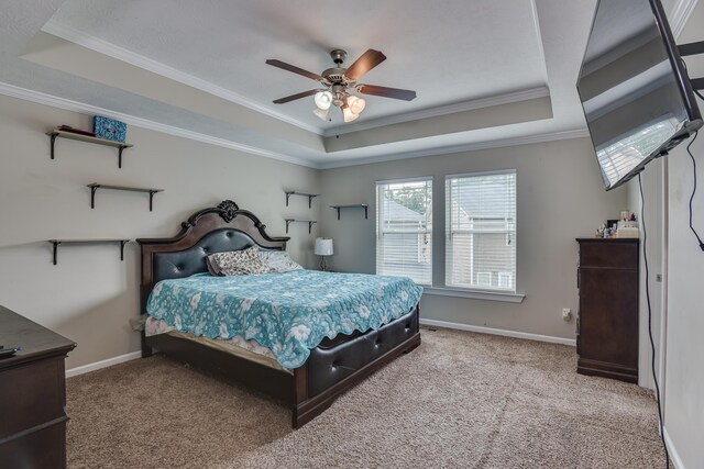 bedroom with ceiling fan, crown molding, and a tray ceiling