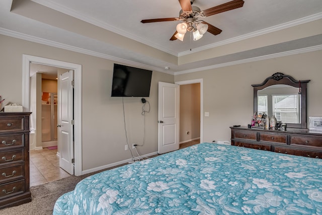 tiled bedroom featuring ceiling fan, ornamental molding, and a tray ceiling