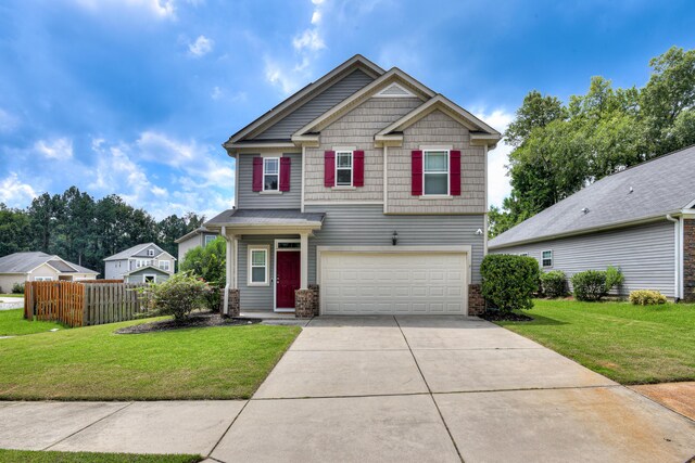 craftsman inspired home with a garage and a front yard