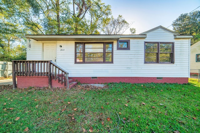 rear view of house with a yard