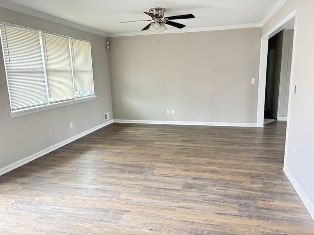 empty room with ceiling fan, dark hardwood / wood-style flooring, and ornamental molding