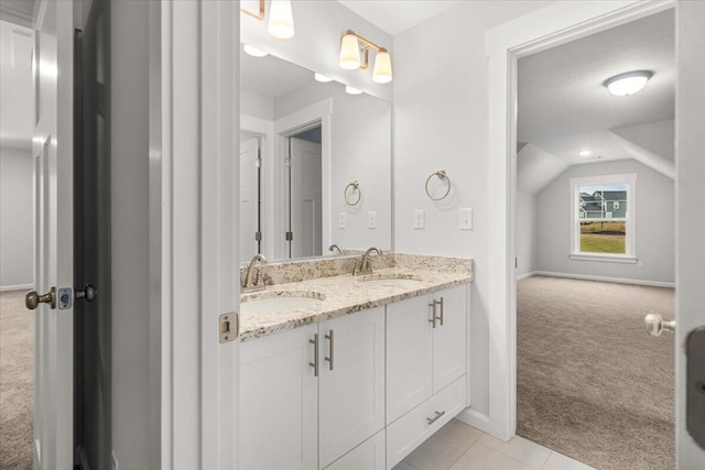 bathroom with lofted ceiling and vanity