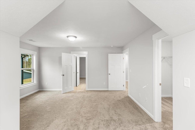 carpeted spare room featuring a textured ceiling