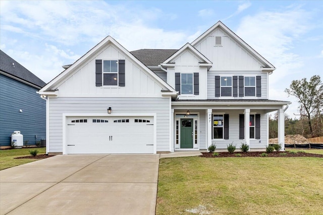 view of front of home featuring a porch, concrete driveway, an attached garage, board and batten siding, and a front lawn