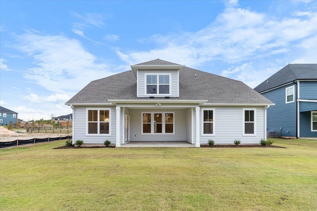 back of house featuring a yard and a patio area