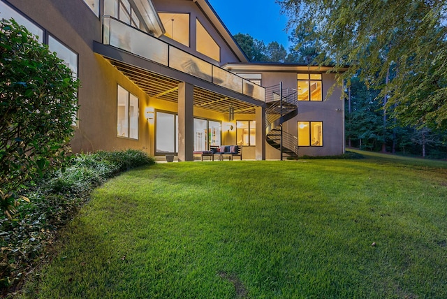 back of house with a yard, a balcony, and a patio area