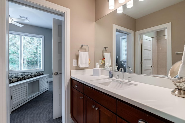 bathroom featuring ceiling fan and vanity