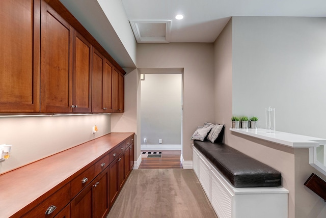 bar with light hardwood / wood-style flooring