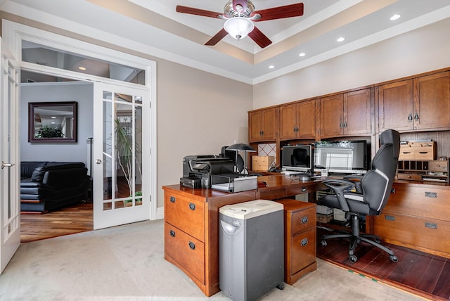 office space with ceiling fan, light carpet, a tray ceiling, and french doors