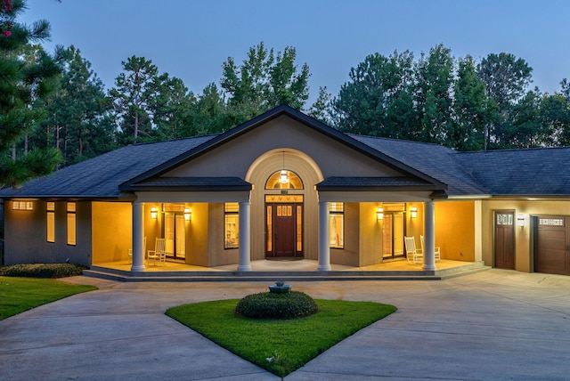 view of front of property featuring a porch and a garage