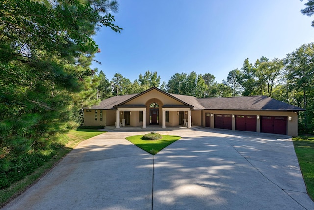 ranch-style house featuring a garage and a front yard