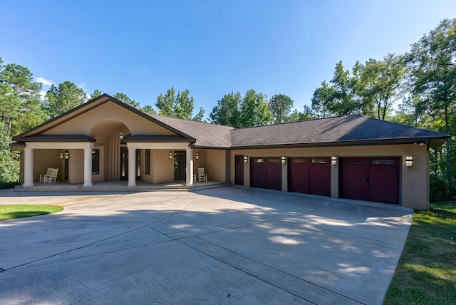 view of front of property with covered porch and a garage