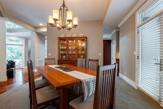 carpeted dining room with a chandelier