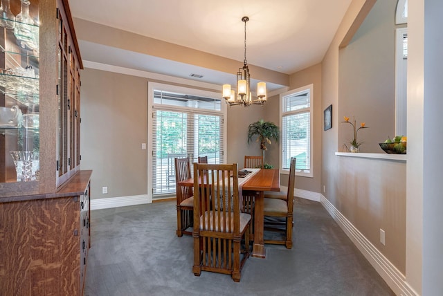 carpeted dining space featuring a chandelier