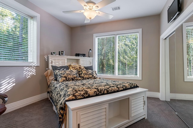 carpeted bedroom featuring ceiling fan and a closet