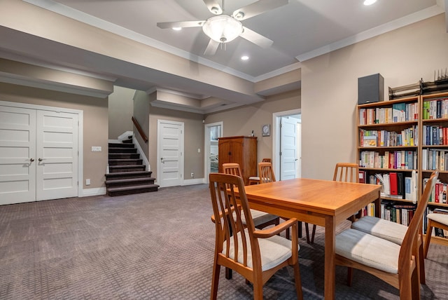 carpeted dining area featuring ceiling fan and crown molding