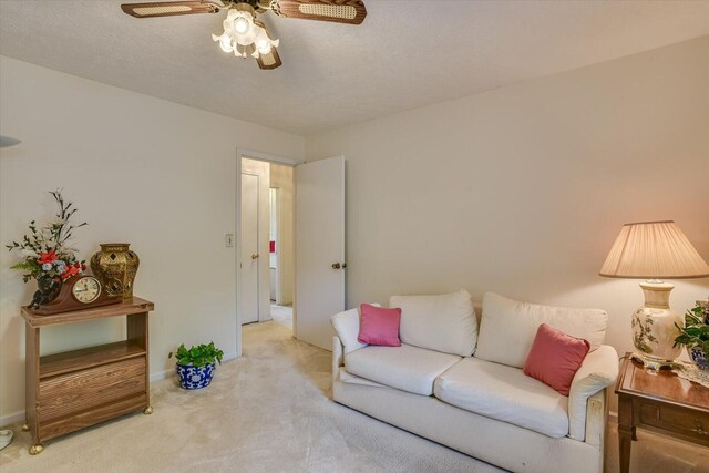 living room with ceiling fan and light colored carpet