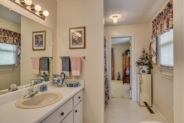 bathroom featuring vanity and a textured ceiling