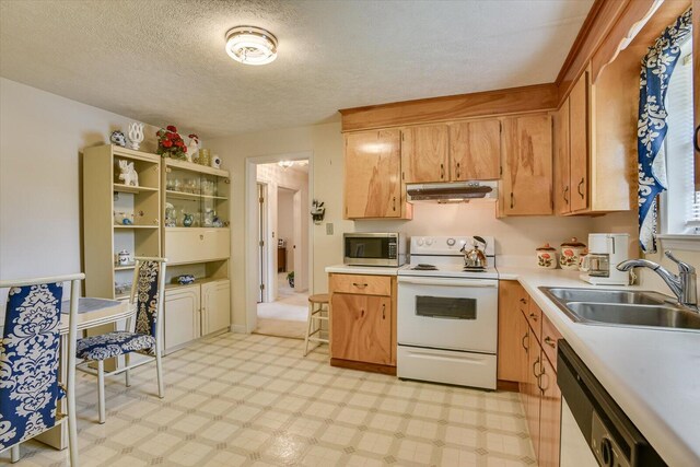 kitchen with a textured ceiling, sink, and stainless steel appliances