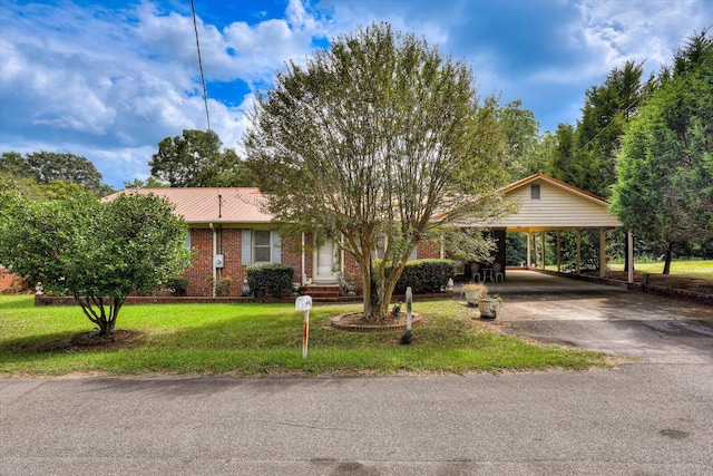 ranch-style home featuring a front lawn and a carport