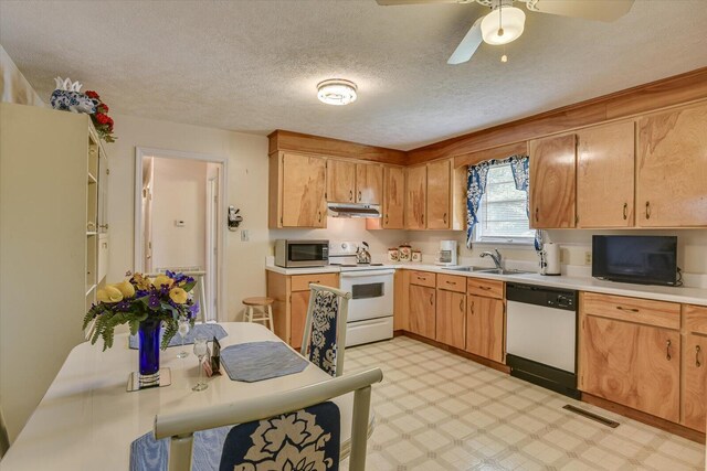 kitchen featuring a textured ceiling, white appliances, ceiling fan, and sink