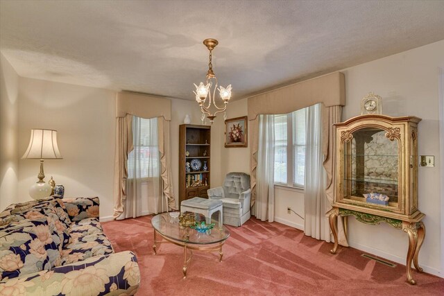 living area featuring carpet flooring, a chandelier, and a textured ceiling