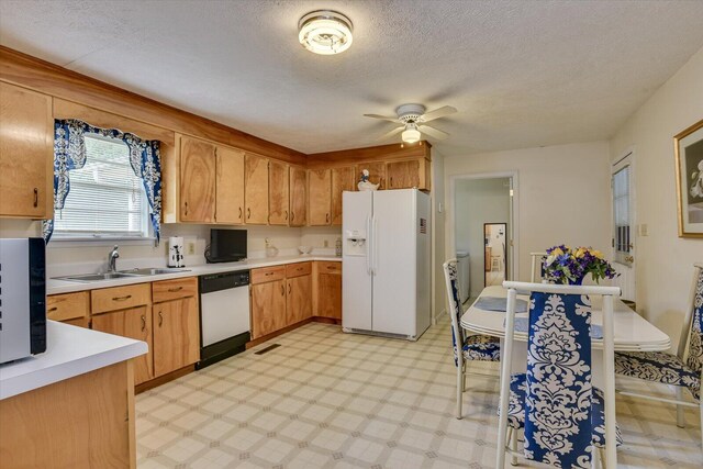 kitchen with a textured ceiling, ceiling fan, sink, and white appliances