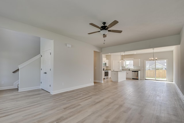 1663 Pine Ridge Dr N, Hephzibah, GA 30815 - unfurnished living room with a ceiling fan, a sink, a chandelier, light wood-style floors, and baseboards