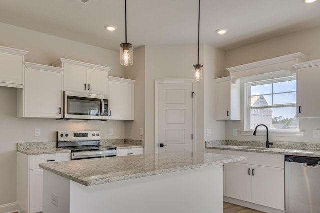 1663 Pine Ridge Dr N, Hephzibah, GA 30815 - kitchen featuring appliances with stainless steel finishes, a sink, a center island, white cabinetry, and recessed lighting