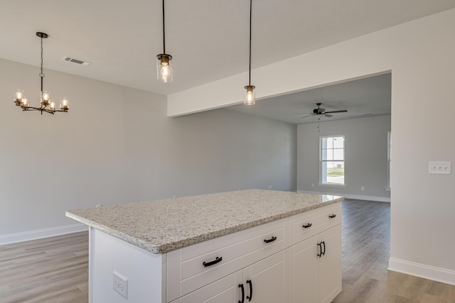 1663 Pine Ridge Dr N, Hephzibah, GA 30815 - kitchen featuring a ceiling fan, baseboards, light wood-type flooring, and a chandelier