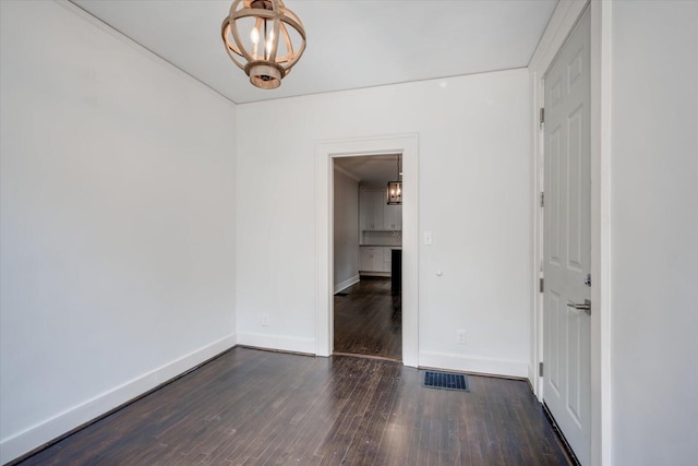2911 Lombardy Ct, Augusta, GA 30909 - unfurnished room featuring a chandelier and dark wood-style floors