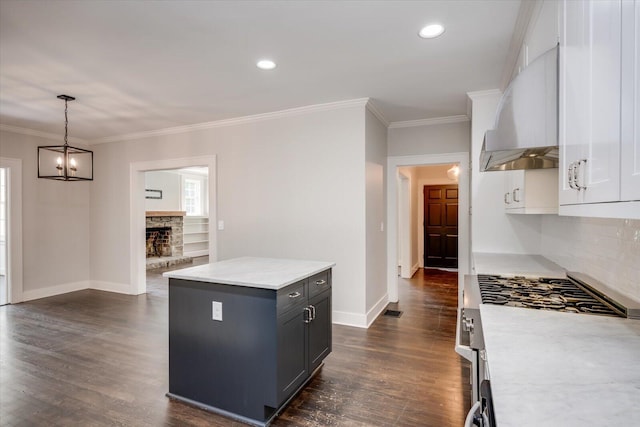 2911 Lombardy Ct, Augusta, GA 30909 - kitchen with ventilation hood, stainless steel range with gas cooktop, tasteful backsplash, a chandelier, and dark wood finished floors