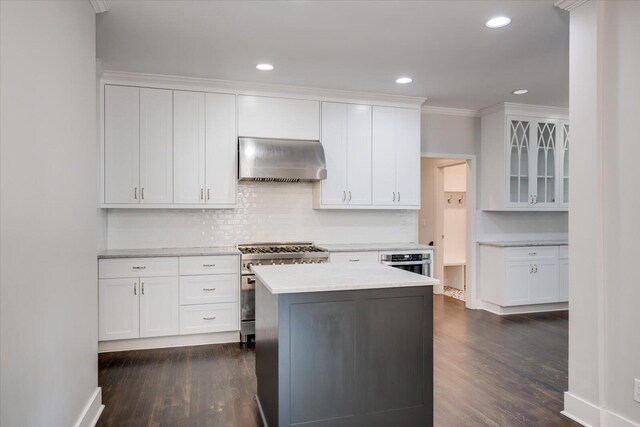 2911 Lombardy Ct, Augusta, GA 30909 - kitchen with ventilation hood, stainless steel appliances, dark wood finished floors, white cabinetry, and tasteful backsplash