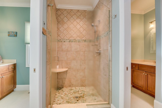 bathroom featuring vanity, a shower with shower door, and ornamental molding