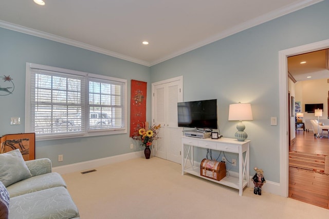 carpeted living room with crown molding