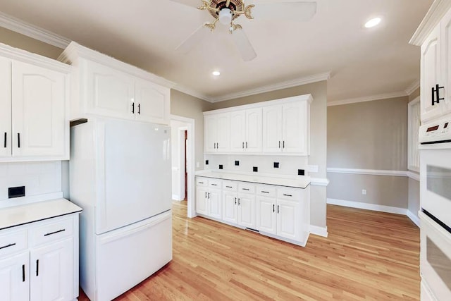 kitchen with tasteful backsplash, white appliances, ceiling fan, light hardwood / wood-style floors, and white cabinetry