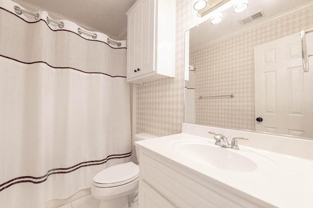 bathroom featuring vanity, toilet, and ornamental molding