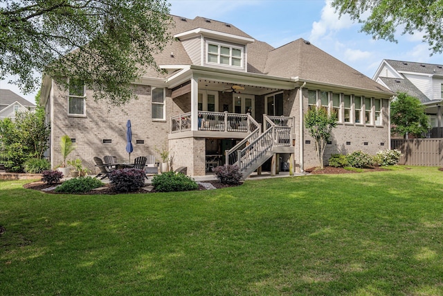 rear view of property featuring stairs, brick siding, a ceiling fan, a patio, and a yard