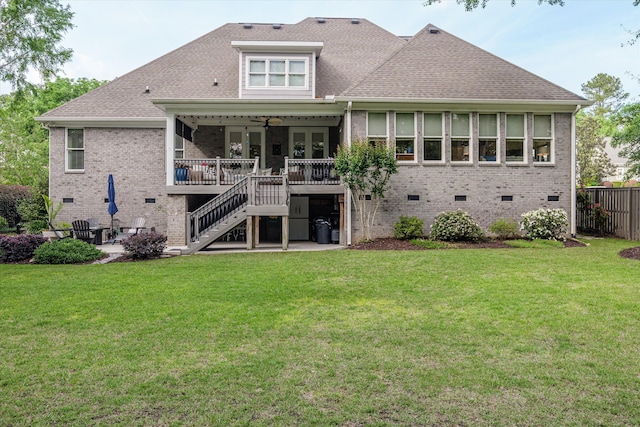 rear view of house with stairway, brick siding, fence, a yard, and a patio