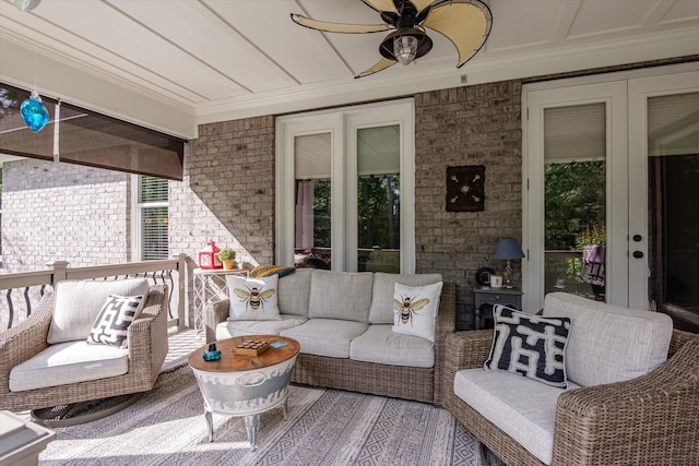 exterior space featuring plenty of natural light, a ceiling fan, and brick wall