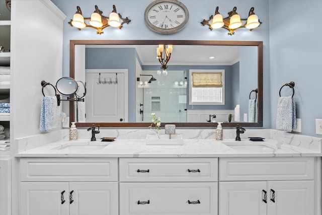 bathroom with crown molding, a sink, and a chandelier