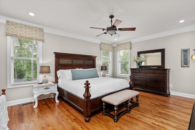 bedroom with light wood-style floors, baseboards, ornamental molding, and visible vents