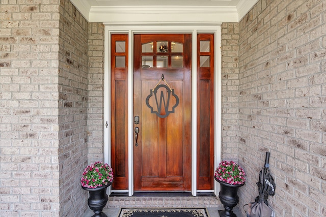 property entrance featuring brick siding