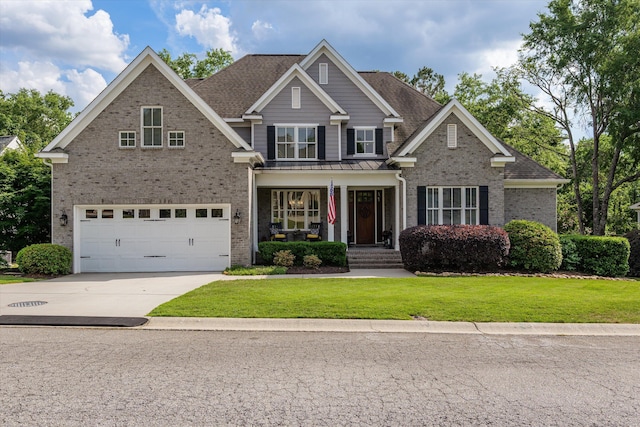 craftsman-style house with a front lawn, brick siding, concrete driveway, an attached garage, and a porch