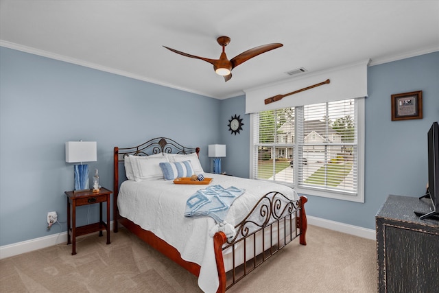 carpeted bedroom with a ceiling fan, baseboards, visible vents, and ornamental molding