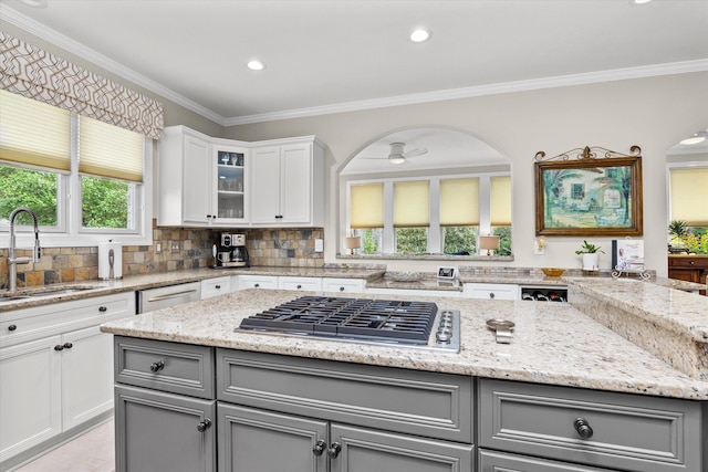 kitchen with a sink, gray cabinets, a healthy amount of sunlight, and stainless steel appliances