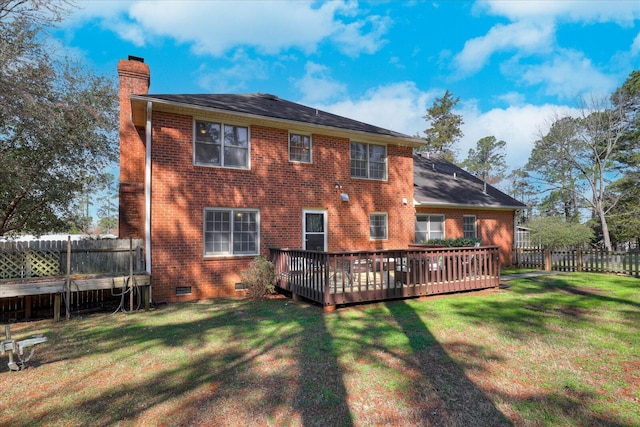 rear view of property with fence, a yard, a chimney, crawl space, and brick siding