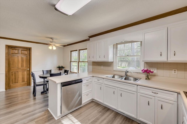 kitchen with a sink, white cabinetry, and stainless steel dishwasher