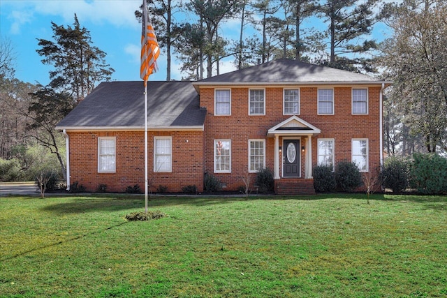 colonial-style house with crawl space, brick siding, and a front yard